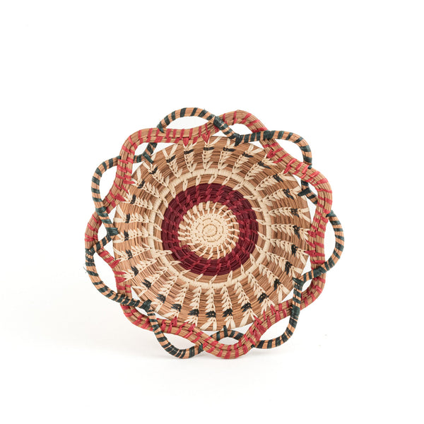 Small curved edge pine needle basket red and green raffia