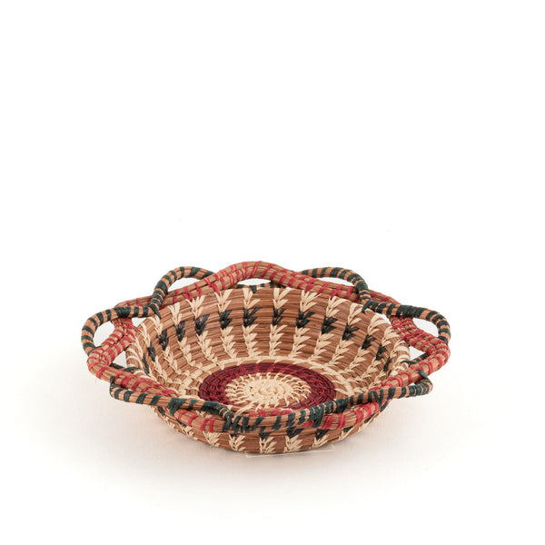 Small curved edge pine needle basket red and green raffia