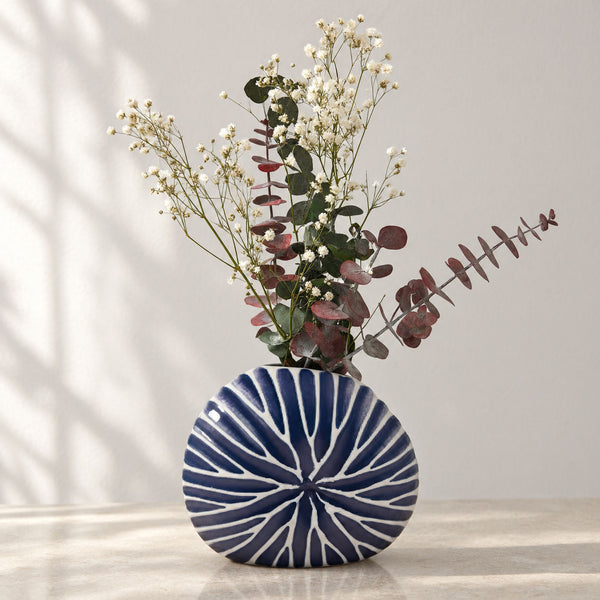 Ceramic freeform disc vase with blue carved ridges