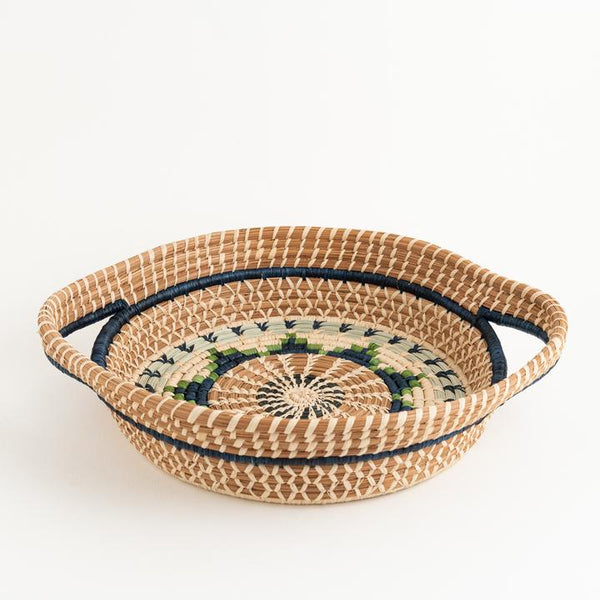 Round pine needle basket with handles in green dyed and undyed raffia