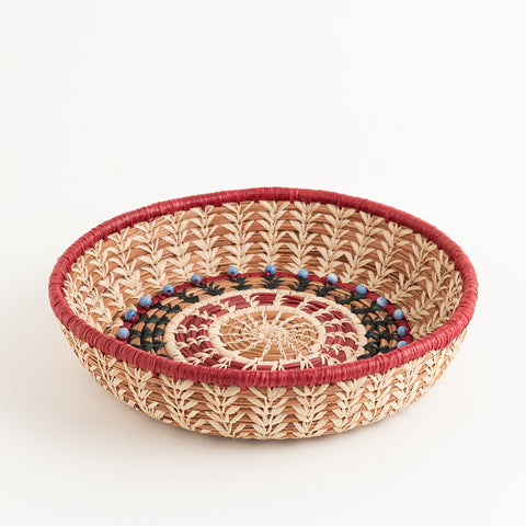 Round pine needle basket with raffia and glass beads
