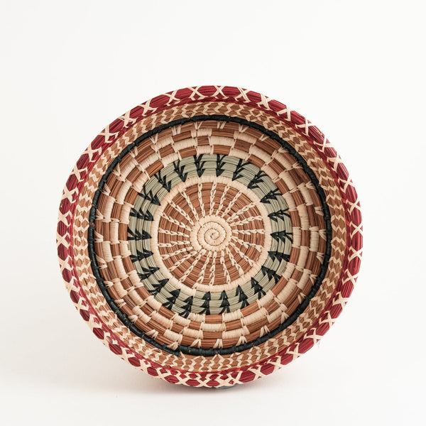Round pine needle basket with dyed and undyed raffia