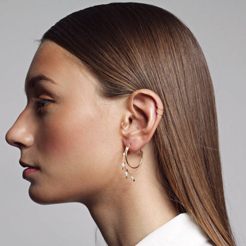 Endless spring hoop earrings in gold and pearls by Meghan Patrice Riley